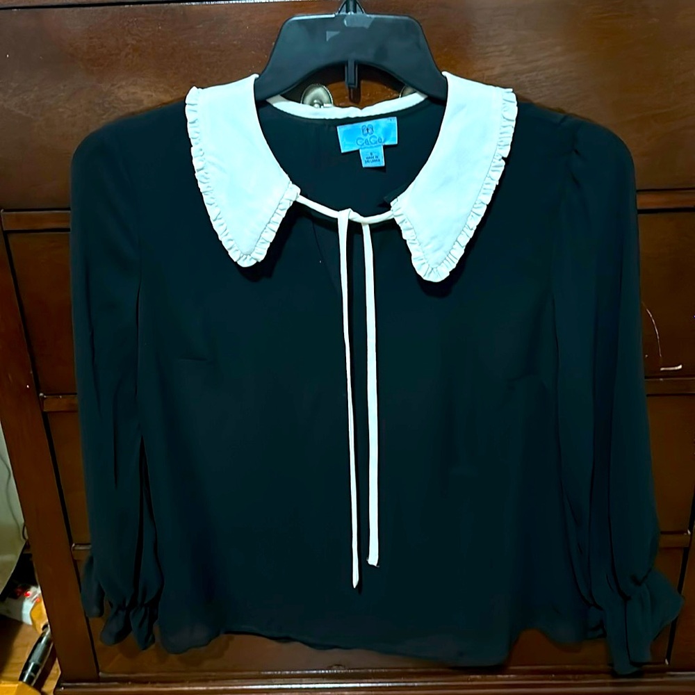Woman’s sheer black blouse.